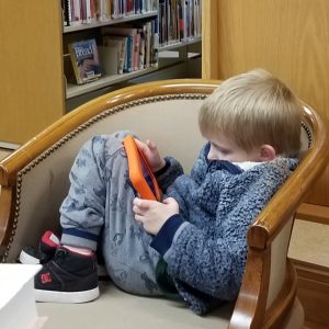 a kid playing on a tablet