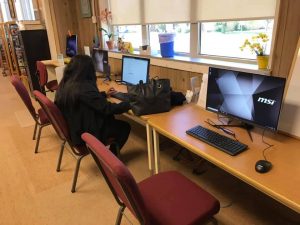 a line of computers at the library